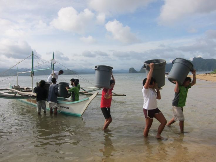 EOs Kring and Mavic help bring in the previous day's trash into the MRF.