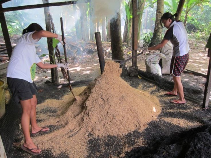 Mixing up the rice hulls for even carbonization