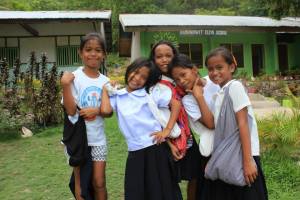 Cheerful students presenting their ecobags 
